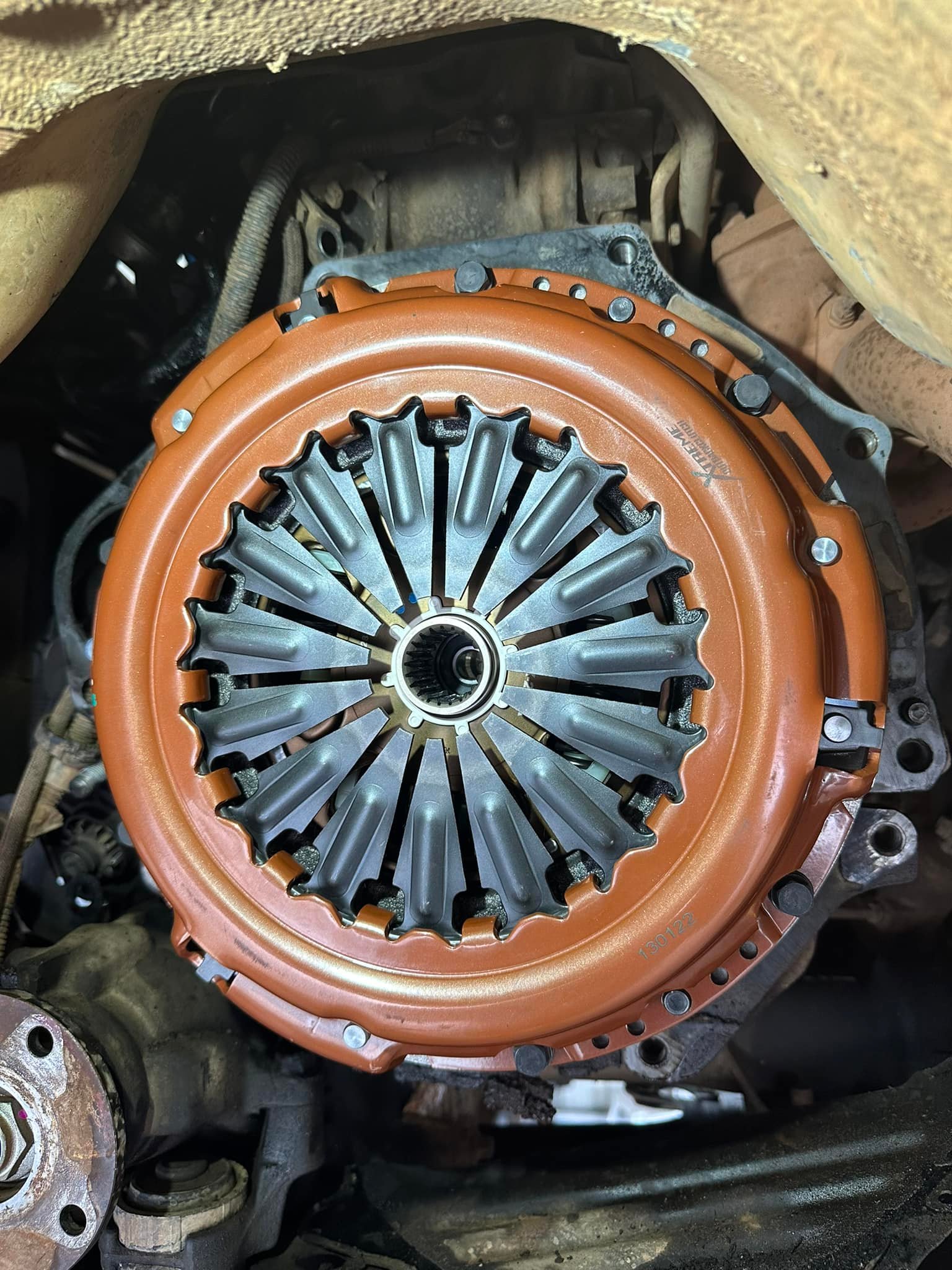 An orange Xtreme Clutch pressure plate bolted up mid clutch replacement at Maito’s Mechanical