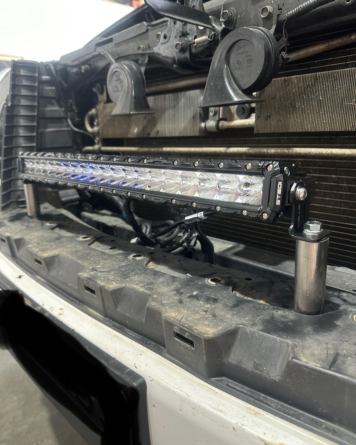 STEDI LED light bar mounted and loomed behind the grille of a ute